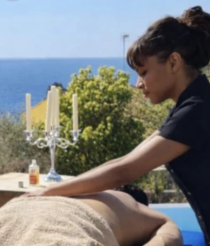 Sylvie, praticienne bien-être diplômée, pratiquant un massage en extérieur sur un homme, disponible également pour les femmes.